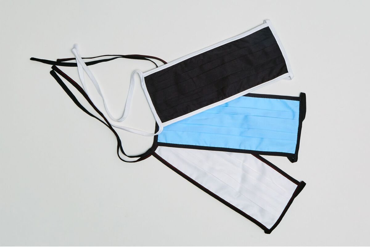 A pack of three cotton jersey masks from Misha Nonoo in blue, white and black.