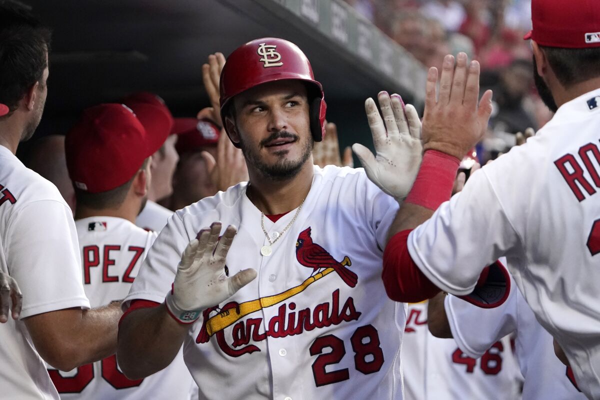 St. Louis Cardinals' Nolan Arenado is congratulated by teammates after hitting a two-run home run during the third inning of a baseball game against the Los Angeles Dodgers Wednesday, July 13, 2022, in St. Louis. (AP Photo/Jeff Roberson)