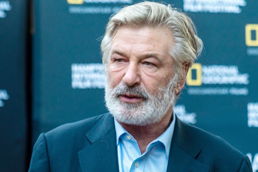 A man with gray hair and a full beard in a blue suit