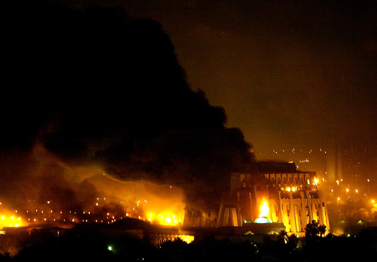 Fire and smoke pour from bombed building 