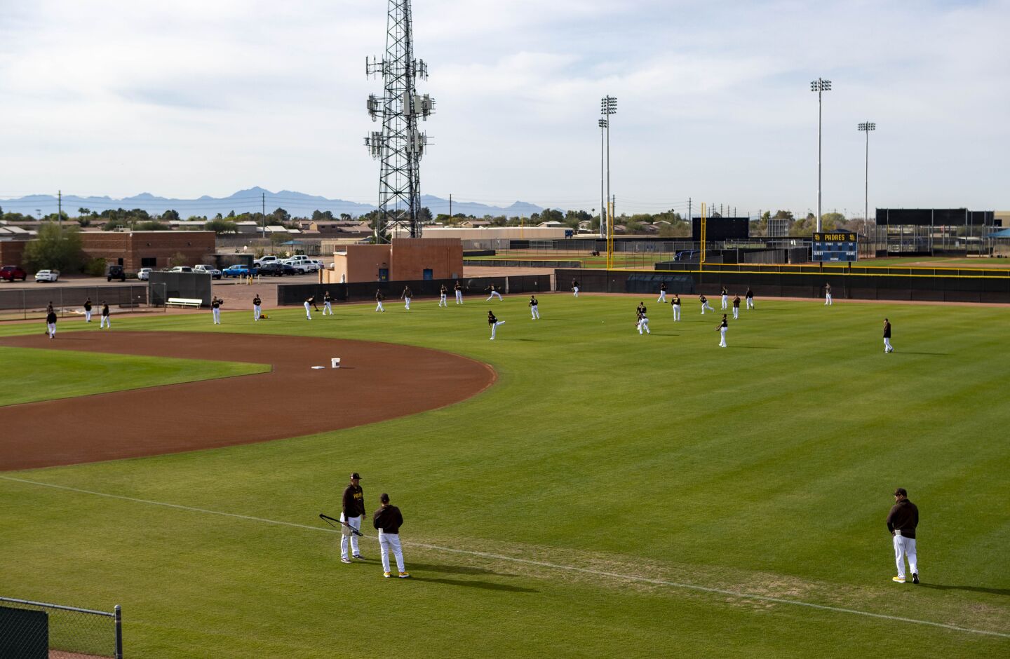 Padres pitchers work out together during a spring training practice at Peoria Sports Complex on Friday.