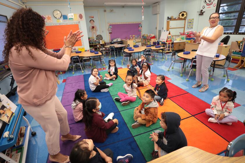 LOS ANGELES CA AUGUST 14, 2023 - TK students clap with teacher Matilde Lopez, right and coach Claudia Mesa, left, on the first day of school at Weemes Elementary School in Los Angeles on Monday, Aug. 14, 2023. (Al Seib / For The Times)