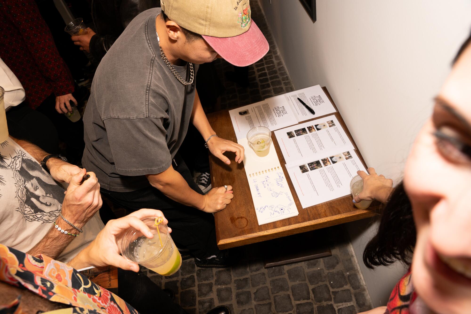 VTProDesign creative director Mike Lee signs the gallery guest book.