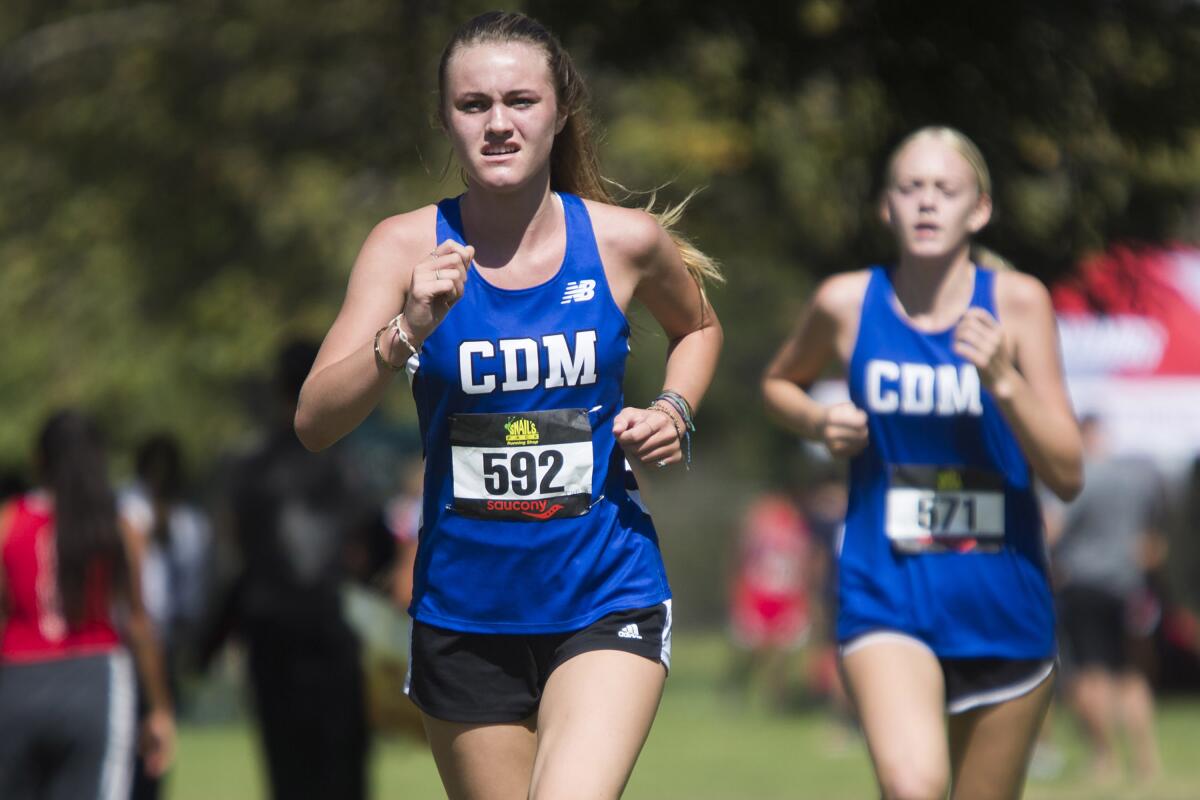 Corona del Mar's Charlee Myers, left, competes in the Central Park Invitational in Huntington Beach on Saturday.
