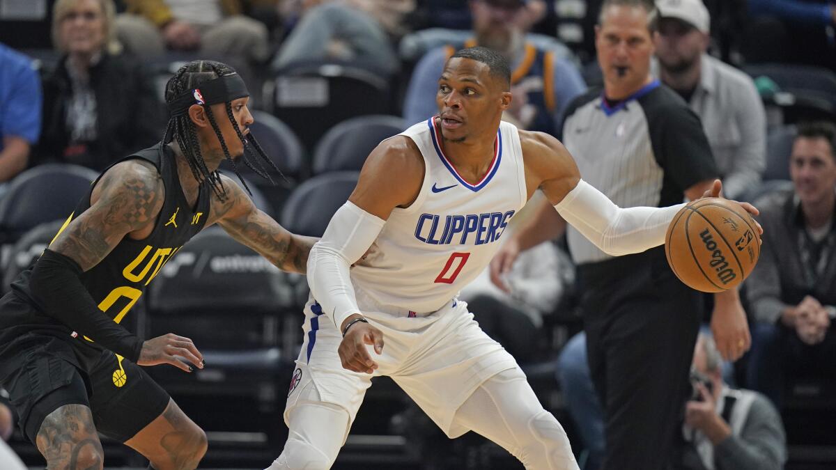 Utah Jazz guard Jordan Clarkson, left, defends Clippers guard Russell Westbrook.