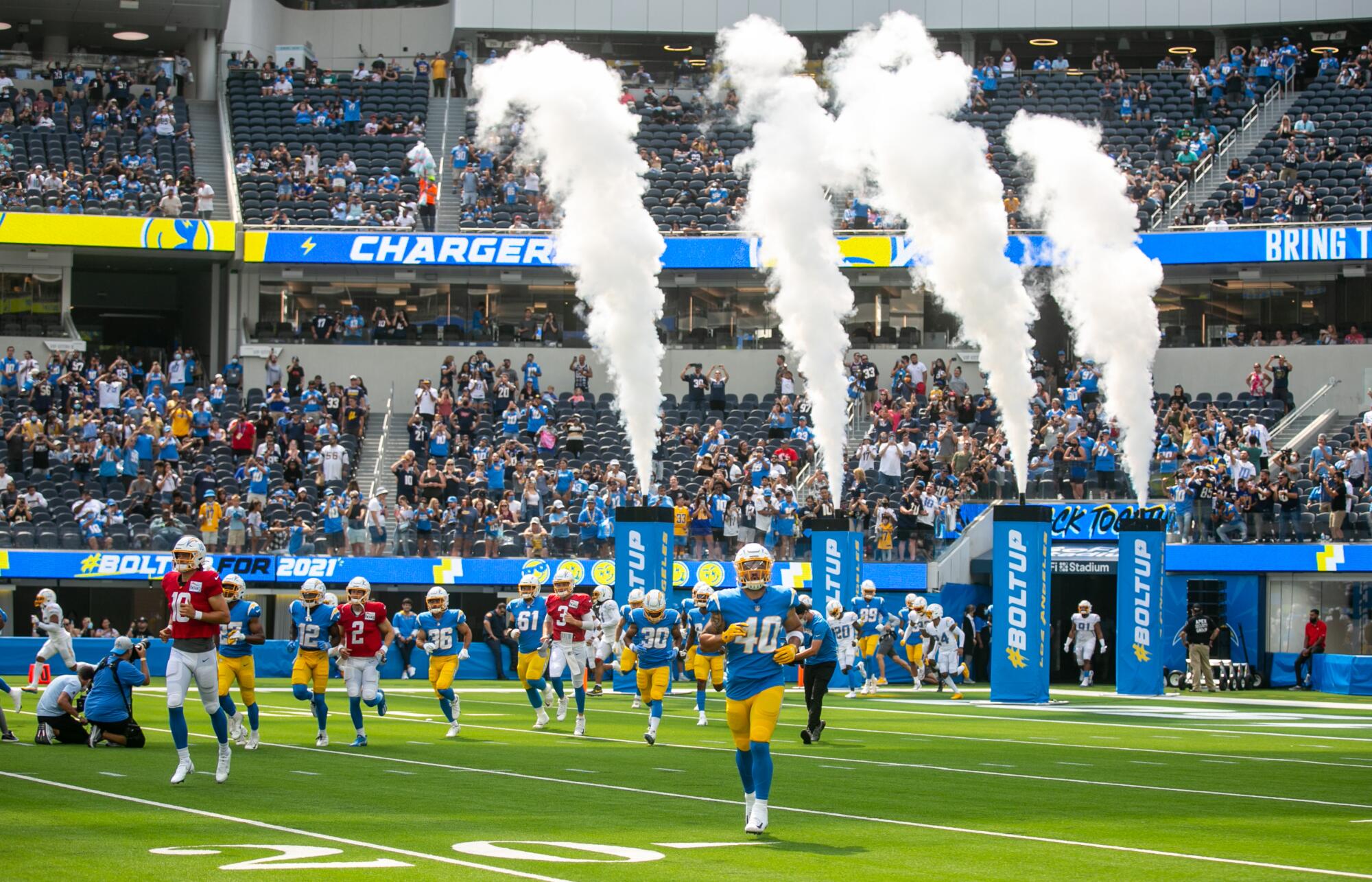 Players enter SoFi Stadium during the Chargers Fan Fest and open practice on Sunday.