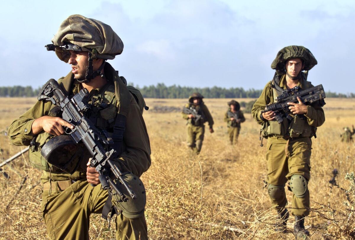 Israeli soldiers take part in a military exercise in the Golan Heights, near the border with Syria, in June. Israel would not comment on reports that its jets carried out an airstrike on a Syrian port city last week.