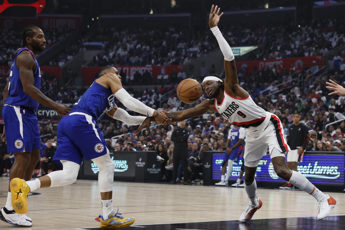 Clippers guard Russell Westbrook fouls Portland's Jerami Grant.