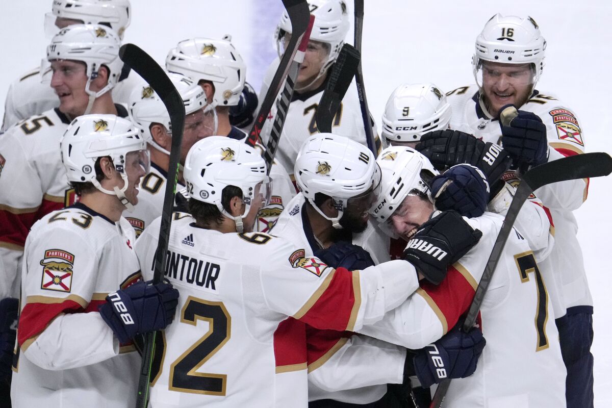 Florida Panthers center Frank Vatrano (77) celebrates with teammates after his overtime goal against San Jose Sharks in an NHL hockey game in San Jose, Calif., Tuesday, March 15, 2022. (AP Photo/Tony Avelar)