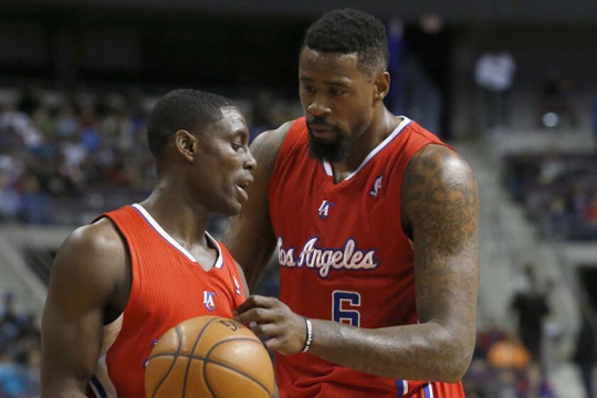 Clippers point guard Darren Collison, left, and center DeAndre Jordan talk during Monday's win over the Detroit Pistons.