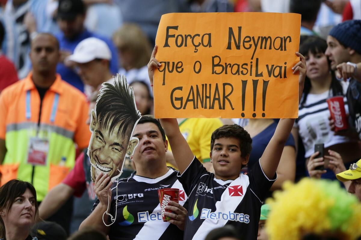 A fan holds up a sign saying, "Power Neymar for Brazil will win!!!" during the World Cup quarterfinal game between Argentina and Belgium on Saturday at Estadio Nacional in Brasilia.