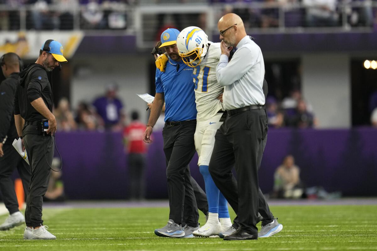 Chargers receiver Mike Williams is helped off the field after injuring his knee against the Vikings.