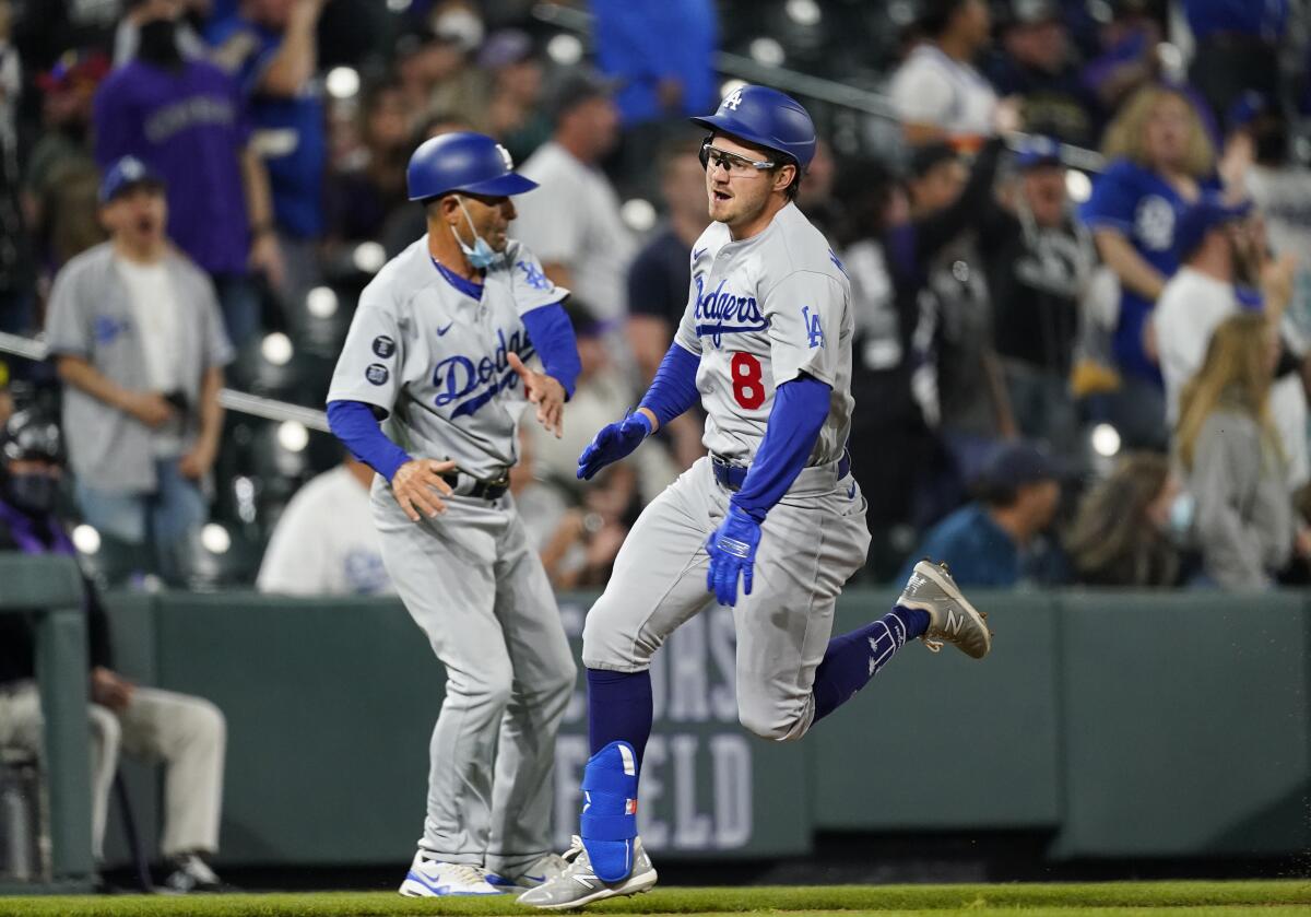 The Dodgers' Zach McKinstry, right, runs around third base on the way to notching an inside-the-park home run April 3, 2021.