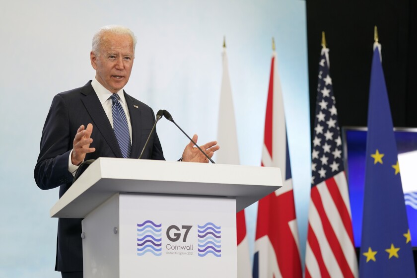 Biden speaks at a lectern that has the words "G7 Cornwall."
