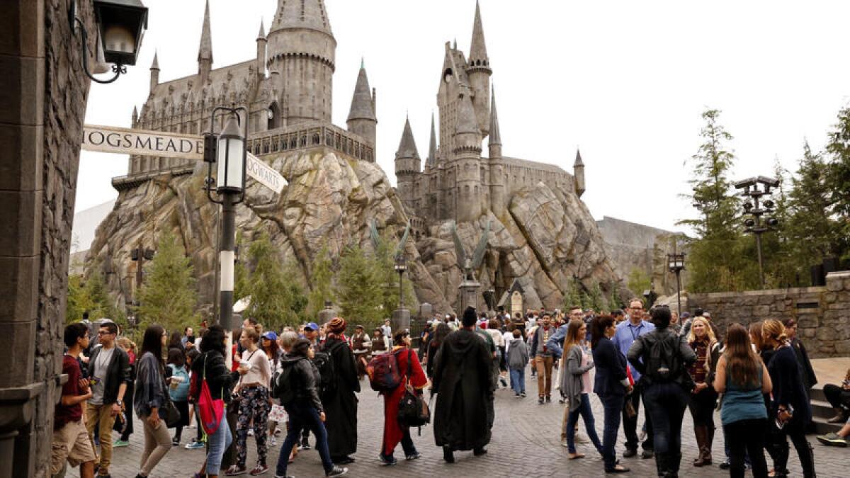Visitors walk around the Wizarding World of Harry Potter attraction at Universal Studios Hollywood.