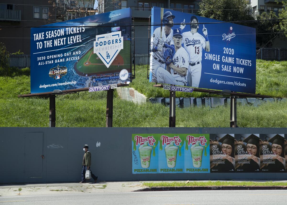 Billboards on Sunset Boulevard near the entrance to Dodger Stadium advertise season tickets and individual game tickets.