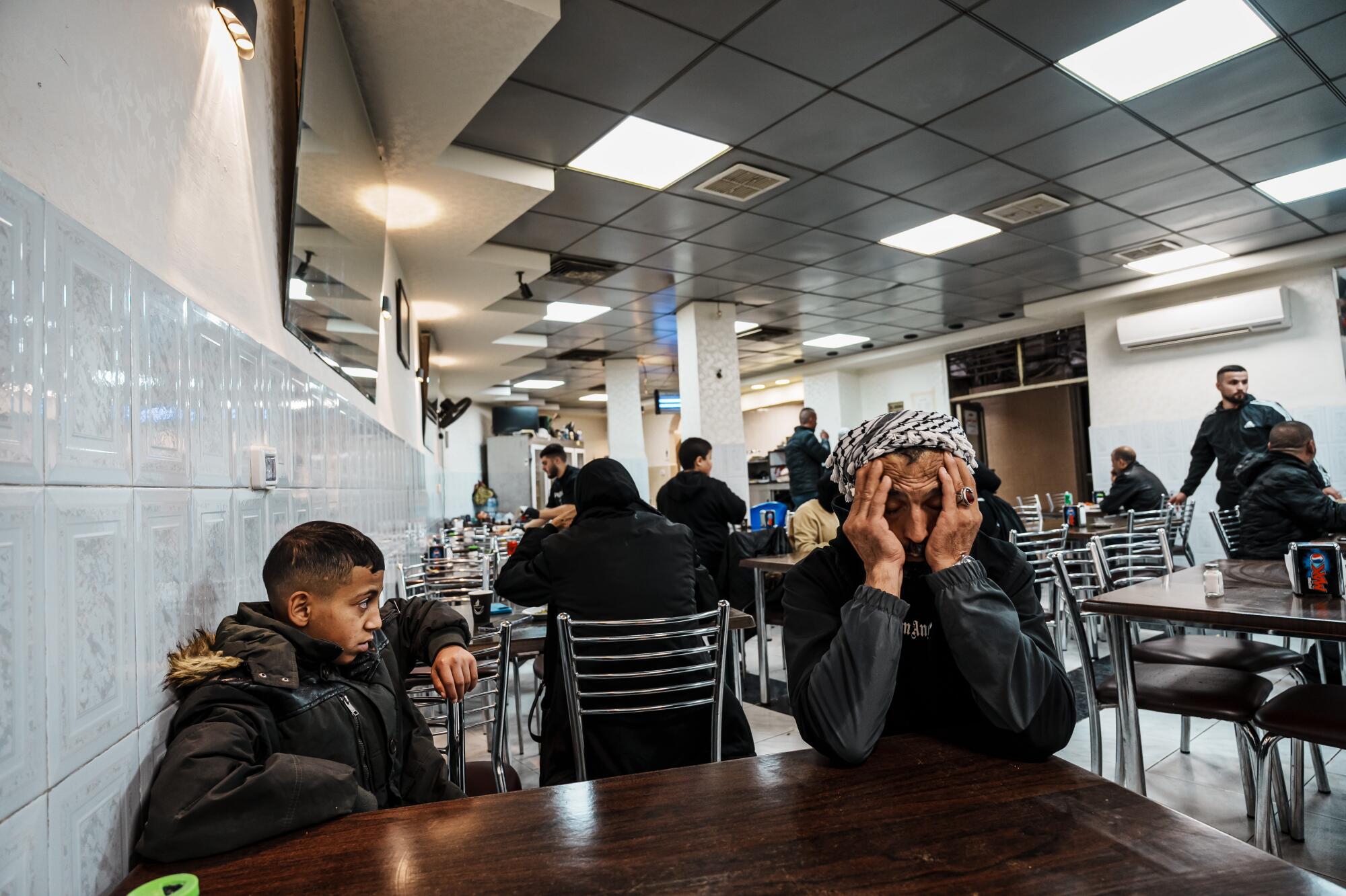 Nawaz Salaymah and his son Ayham Salaymah, 13, sit down for lunch after AyhamOs court appearance