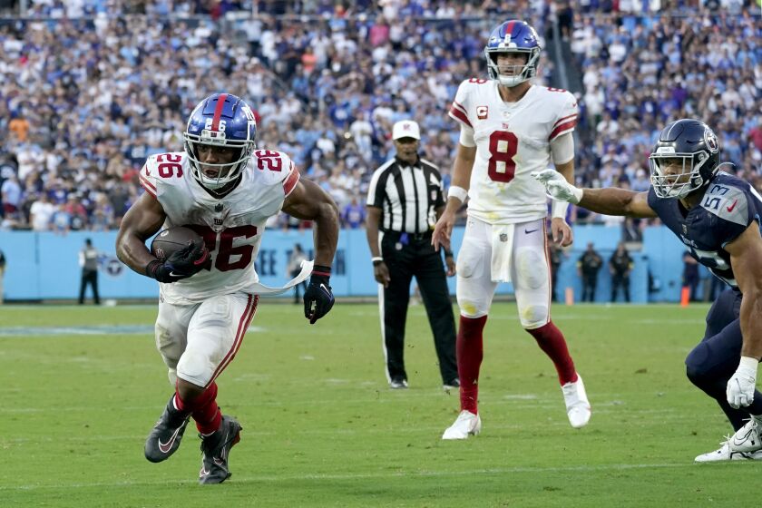 New York Giants running back Saquon Barkley (26) scores on a 2-point conversion against the Tennessee Titans in the fourth quarter of an NFL football game Sunday, Sept. 11, 2022, in Nashville, Tenn. (AP Photo/Mark Humphrey)