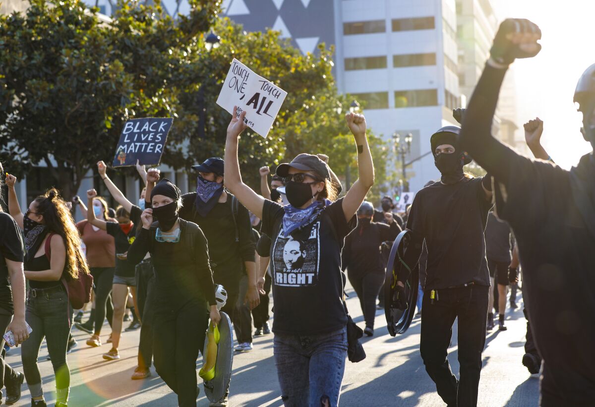 Protesters held a demonstration that began in front of San Diego police headquarters and continued as they marched downtown
