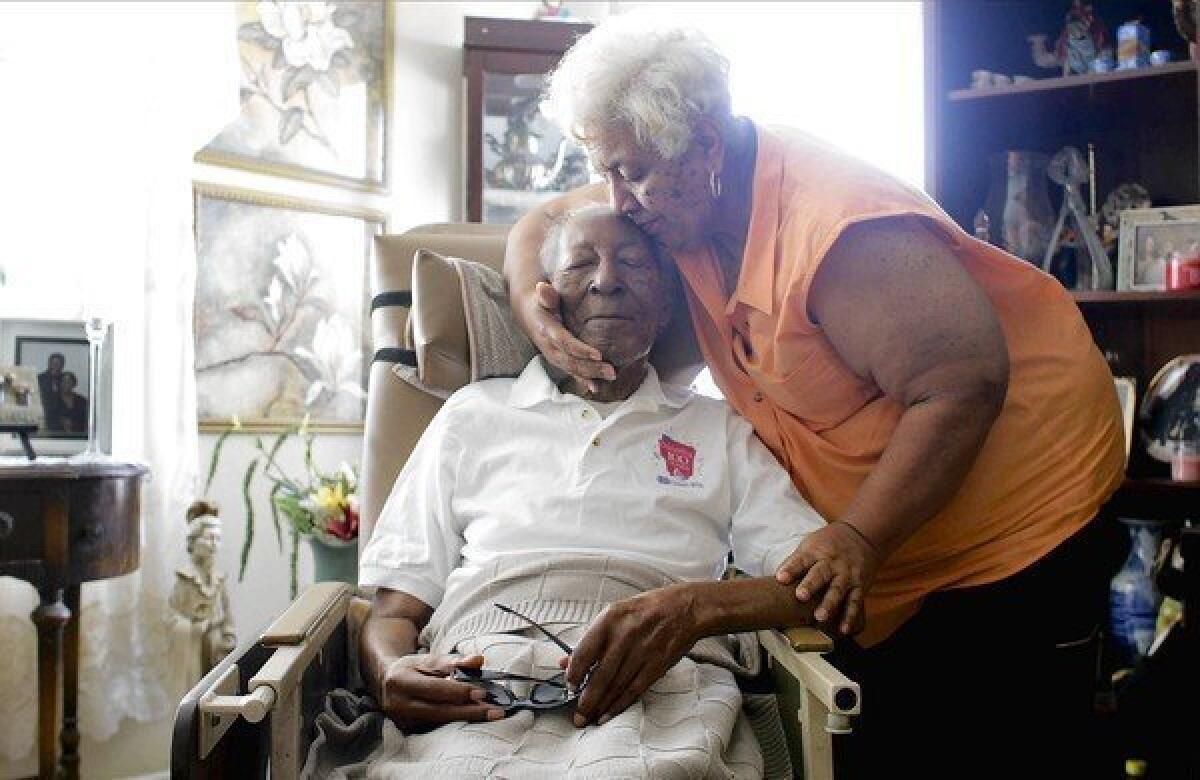 Ben Isaacs gets a hug from daughter Dolores White in 2010. "I just kind of liked traveling around and seeing the country, and helping people," he said of his job as a Pullman porter. Isaacs has died at age 107.