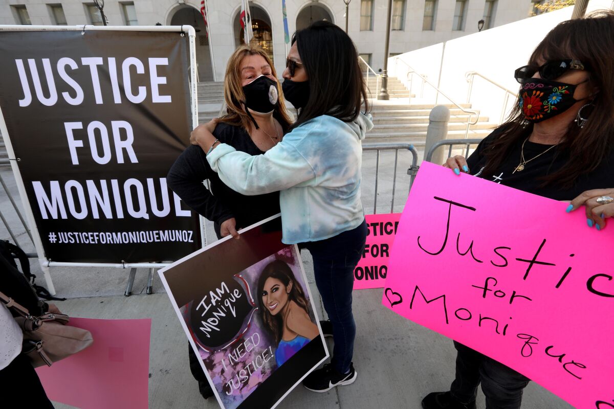 People with signs that say Justice for Monique