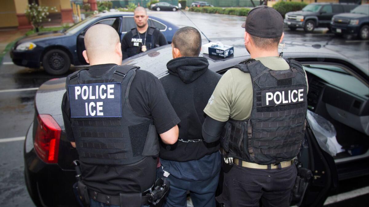 U.S. Immigration and Customs Enforcement agents make an arrest during an operation earlier this month in the Los Angeles area. ICE officials this week told the city of Santa Ana that they were ending their agreement to house immigration detainees at the city's jail.