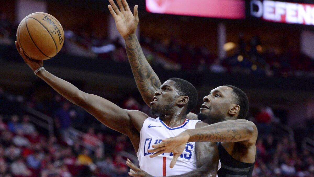 Clippers point guard Jawun Evans tries to score on a layup against Rockets forward Tarik Black during the first half Friday night in Houston.