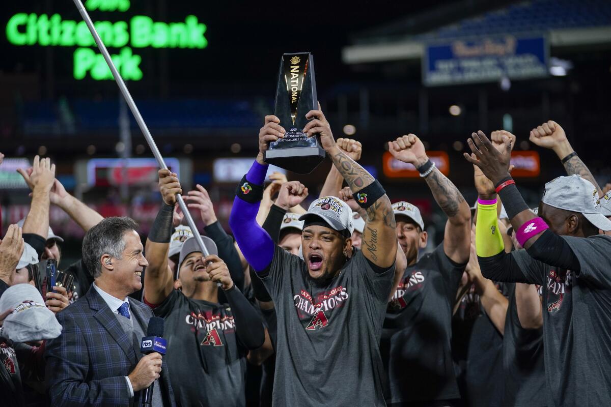 Arizona Diamondbacks second baseman Ketel Marte holds up the MVP award after Game 7 of the NLCS on Oct. 24, 2023.