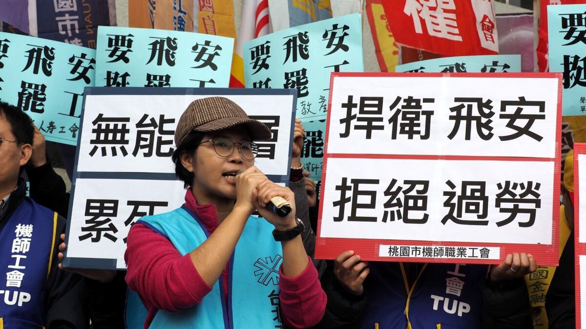 Representatives from 60 trade unions rally to support striking pilots of Taiwan's China Airlines on Feb. 11 in Taipei, Taiwan.