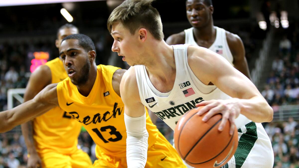 Michigan State's Matt McQuaid tries to drive past Long Beach State's Barry Ogalue during their game Thursday night.