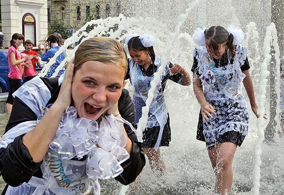 School graduates splash in a fountain as they celebrate the last day at school in Kiev, Ukraine. About 704,000 young Ukrainians today will celebrate Last Ring, a celebration of their last day of school.