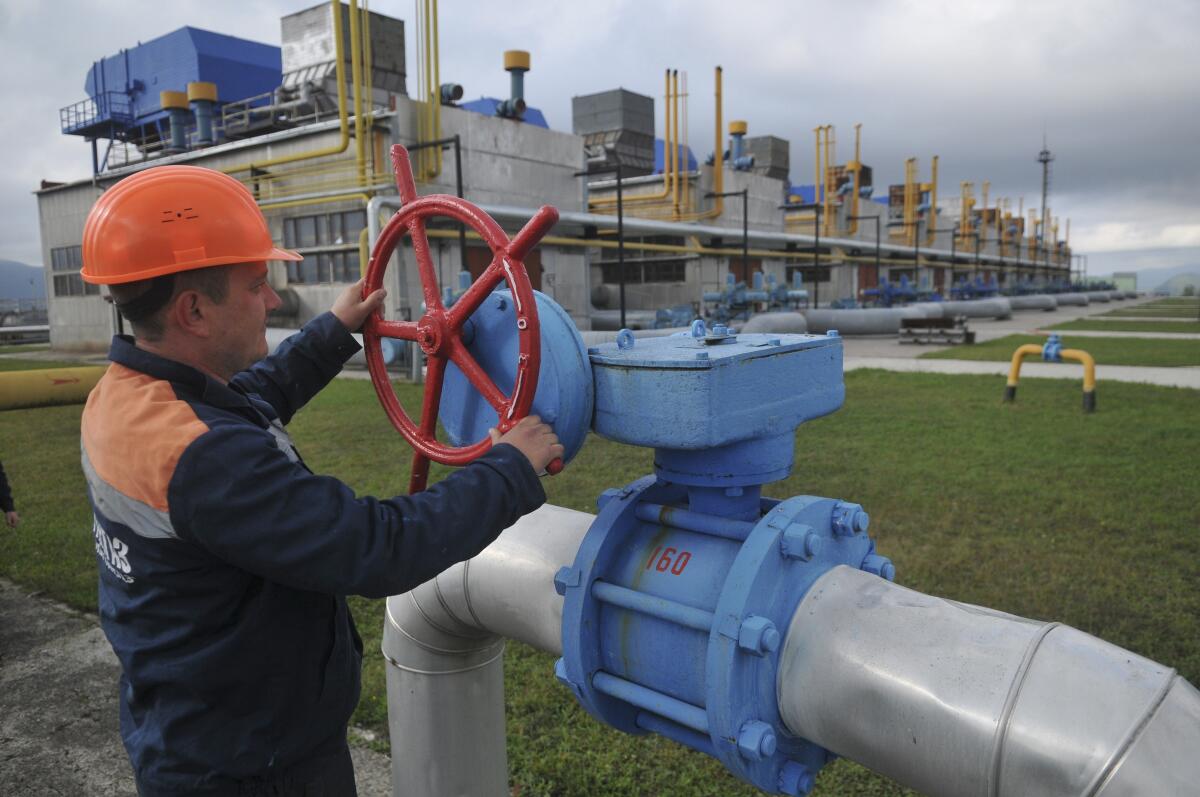 Worker turning valve at Ukrainian natural gas depot