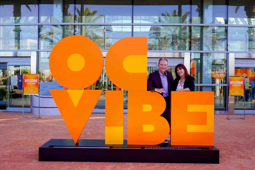 Henry and Susan Samueli, owners of the Anaheim Ducks, pose for a photo at OC Vibe.