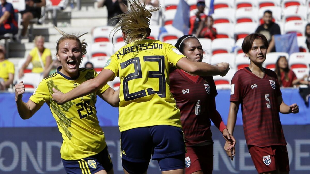 Sweden's Mimmi Larsson, left, and teammate Elin Rubensson celebrate a goal against Thailand on Sunday.