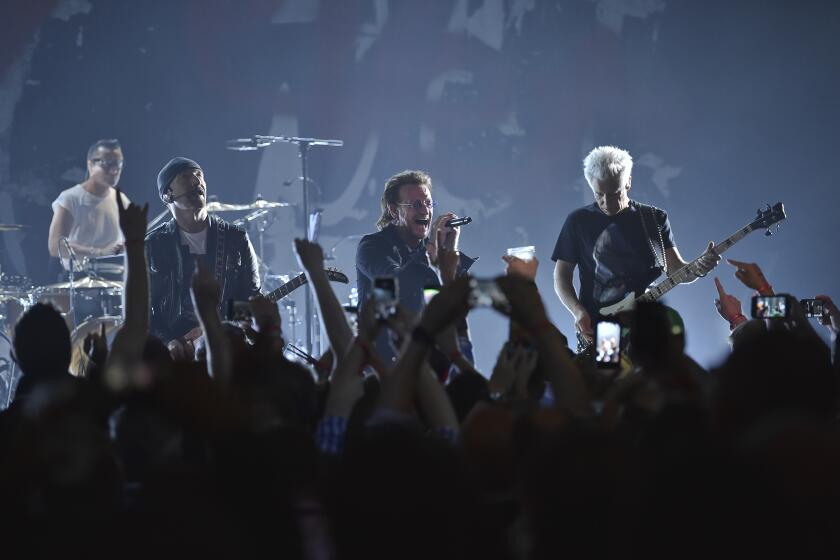 a band performing onstage in front of a crowd