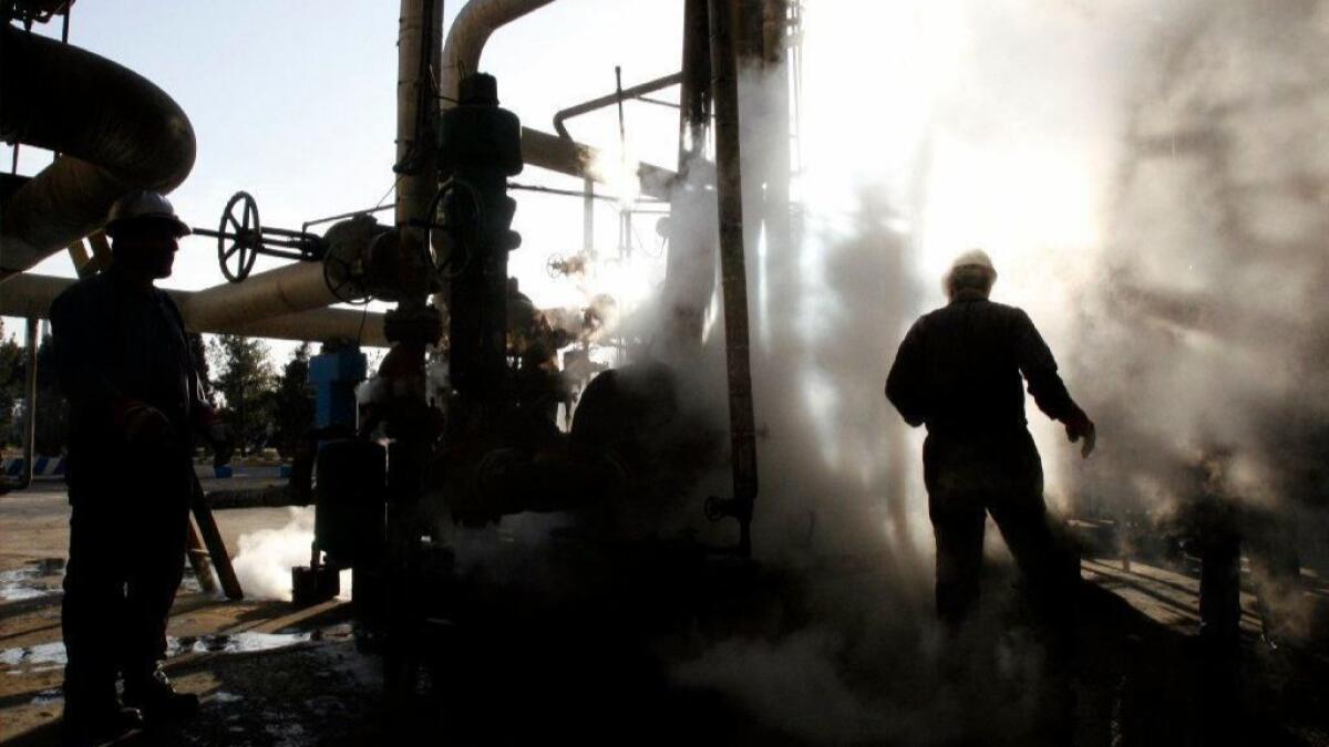 A worker repairs a part of a unit of the Tehran oil refinery. Iran is once again facing sanctions by the U.S. on oil exports.