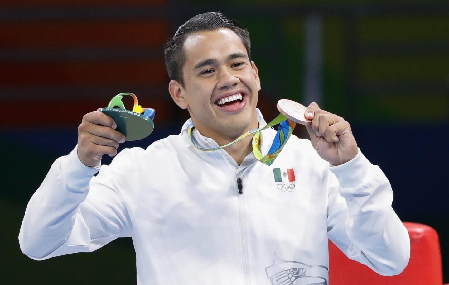 Misael Uziel Rodriguez of Mexico poses with his bronze medal on the podium of the men's Middle (75kg) competition of the Rio 2016 Olympic Games Boxing events.