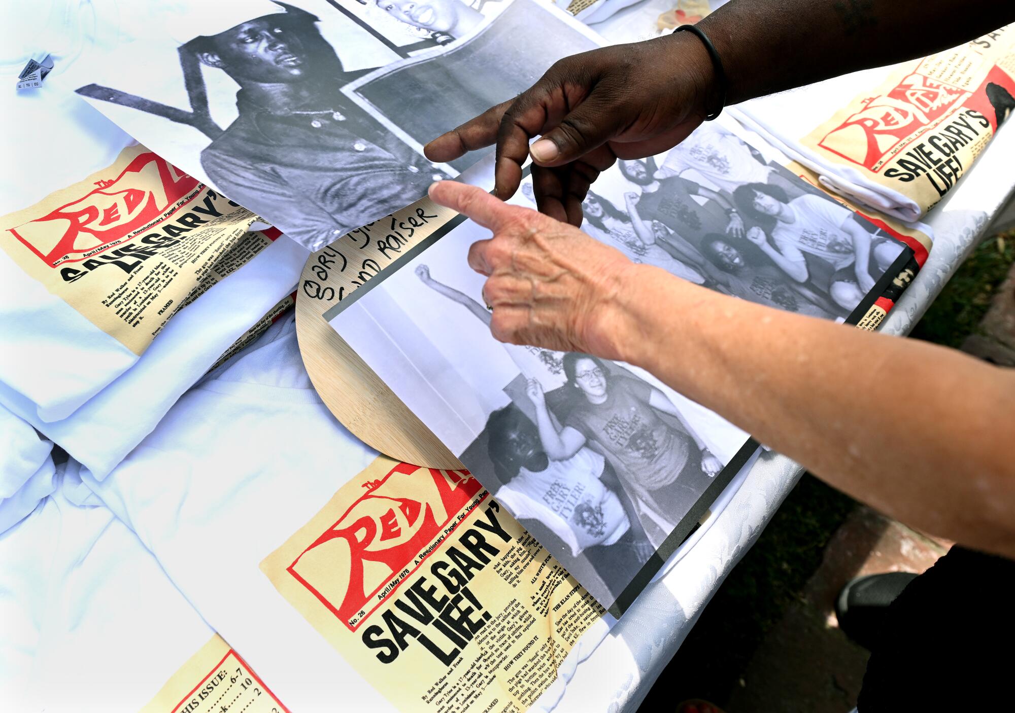 Gary Tyler points to photos and mementos