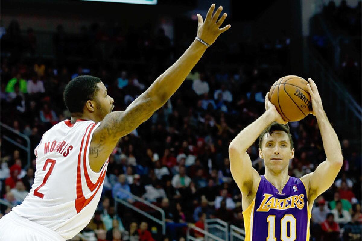 Steve Nash, looking to pass over Houston's Marcus Morris, became just the fifth player in NBA history to reach 10,000 career assists during the Lakers' game against the Clippers Tuesday night.