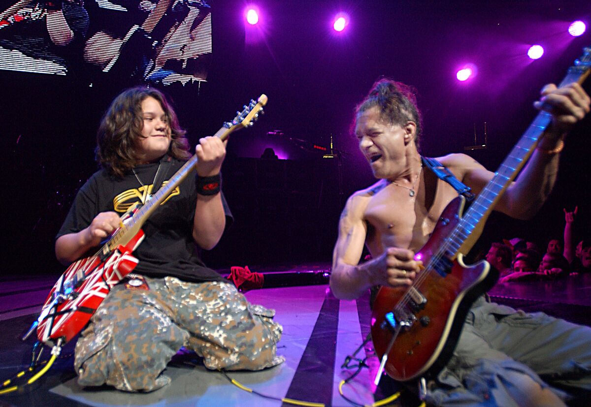 Van Halen's Wolfgang Van Halen and Eddie Van Halen perform in 2004.