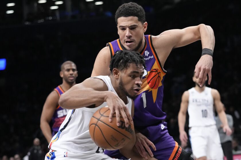 Brooklyn Nets guard Cam Thomas drives against Phoenix Suns guard Devin Booker (1) during the first half of an NBA basketball game, Tuesday, Feb. 7, 2023, in New York. (AP Photo/Mary Altaffer)