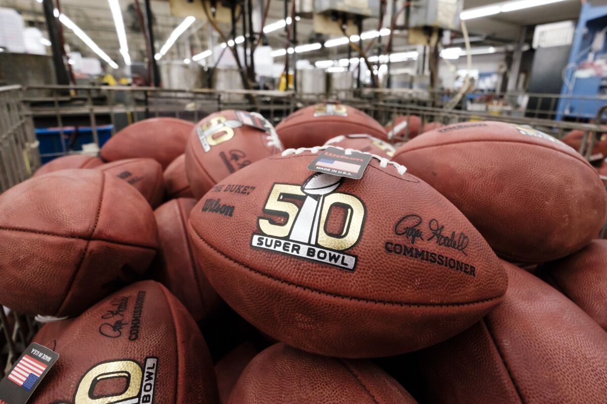 Official balls for the NFL Super Bowl 50 football game are seen in a bin prior to final inspection at the Wilson Sporting Goods Co.