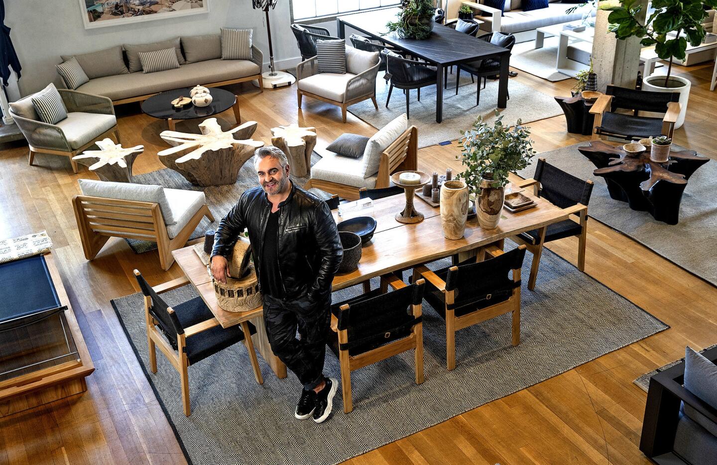Interior designer Martyn Lawrence Bullard at Harbour Outdoor in Los Angeles. The dining chairs are shown in natural teak finish with olefin Copacabana midnight fabric and the table is shown in natural teak finish and brass accents.