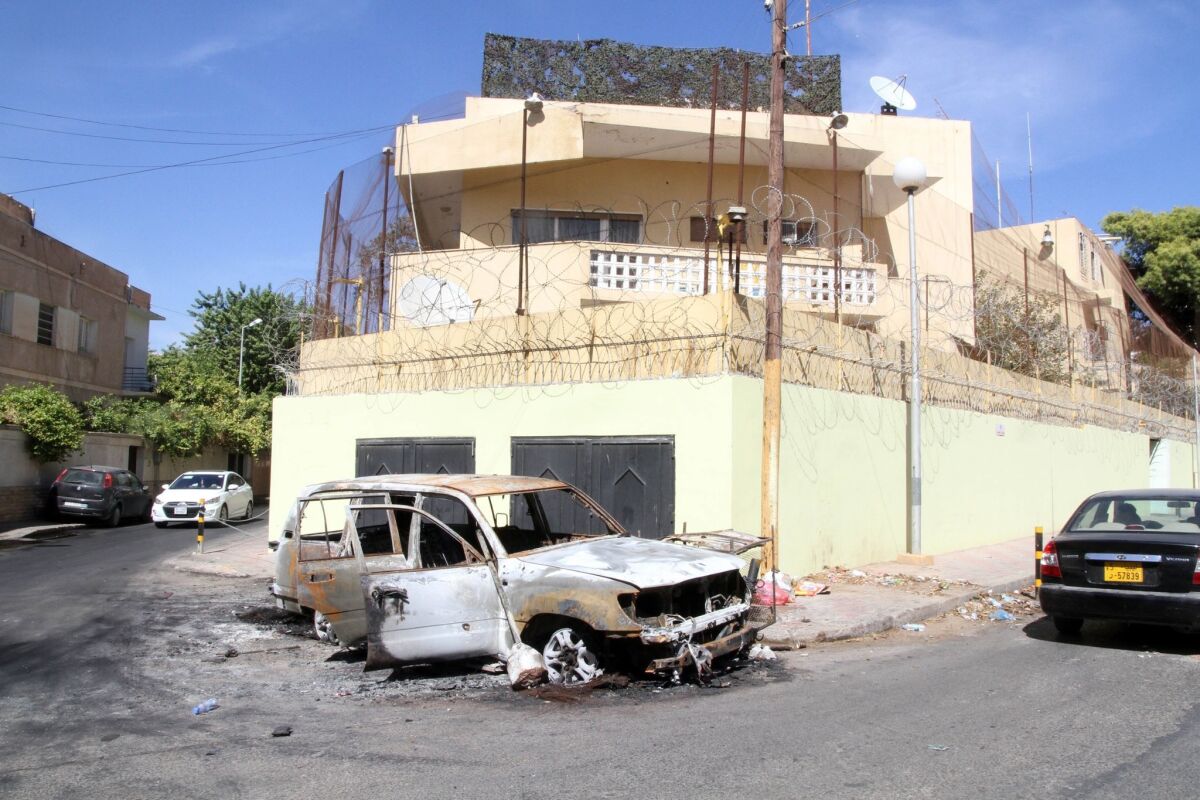 A picture taken Thursday outside the Russian Embassy in Tripoli shows a car destroyed by demonstrators the day before. Dozens of angry protesters tried to storm the embassy after reports that a Russian woman had killed a Libyan army officer, witnesses said.