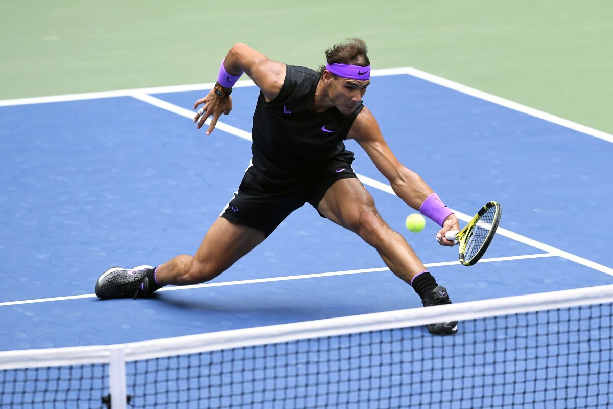 FILE - In this Sept. 8, 2019, file photo, Rafael Nadal, of Spain, returns a shot to Daniil Medvedev, of Russia, during the men's singles final of the U.S. Open tennis championships in New York. Defending champion Rafael Nadal will skip the U.S. Open because of the coronavirus pandemic. (AP Photo/Sarah Stier, File)