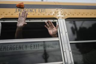 Nicaraguan citizens wave from a bus after being released from a Nicaraguan jail and landing at the airport in Guatemala City, Thursday, Sept. 5, 2024. (AP Photo/Moises Castillo)