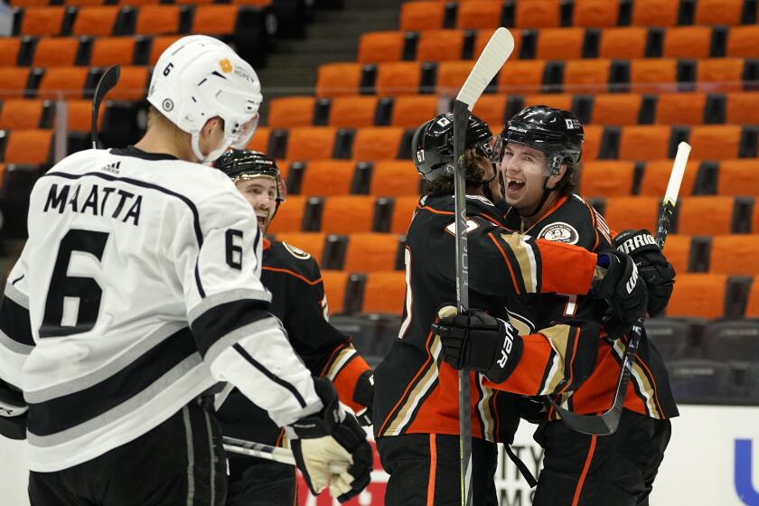 Anaheim Ducks defenseman Ben Hutton, right, celebrates his goal with center Rickard Rakell, second from right, as Los Angeles Kings defenseman Olli Maatta stands by during the second period of an NHL hockey game Monday, March 8, 2021, in Anaheim, Calif. (AP Photo/Mark J. Terrill)