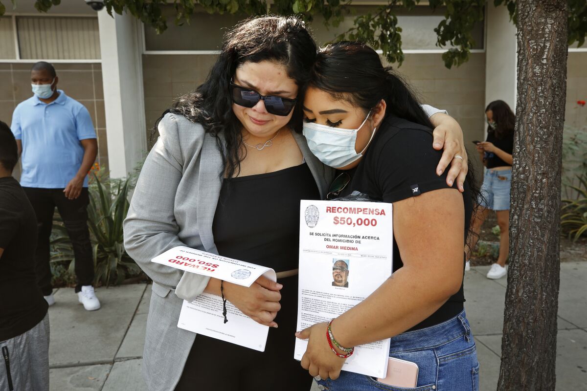 Stephanie Rodriguez, left, comforts Brianna Medina, after a press conference for families who have had family members killed