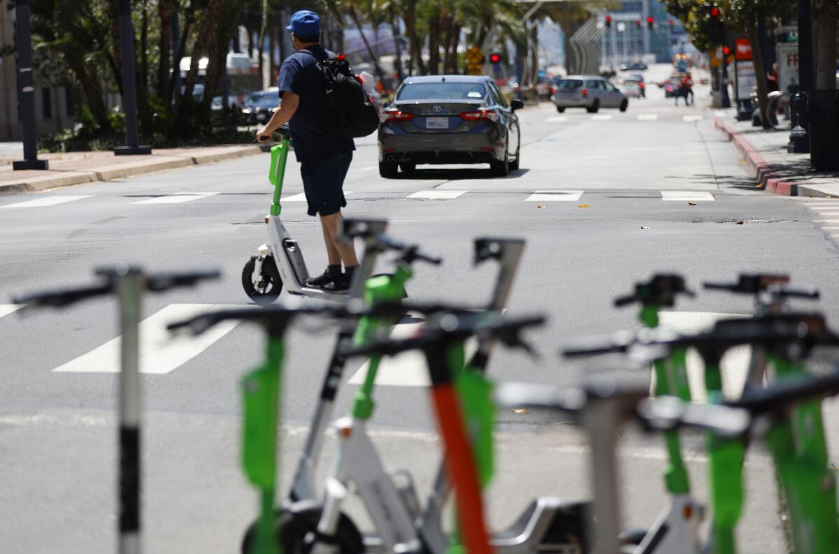 Bird and Lime scooters were lined up on Broadway in downtown San Diego on Thursday.