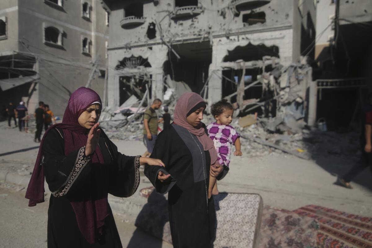 Palestinians leave their houses after Israeli airstrikes in a Rafah refugee camp.